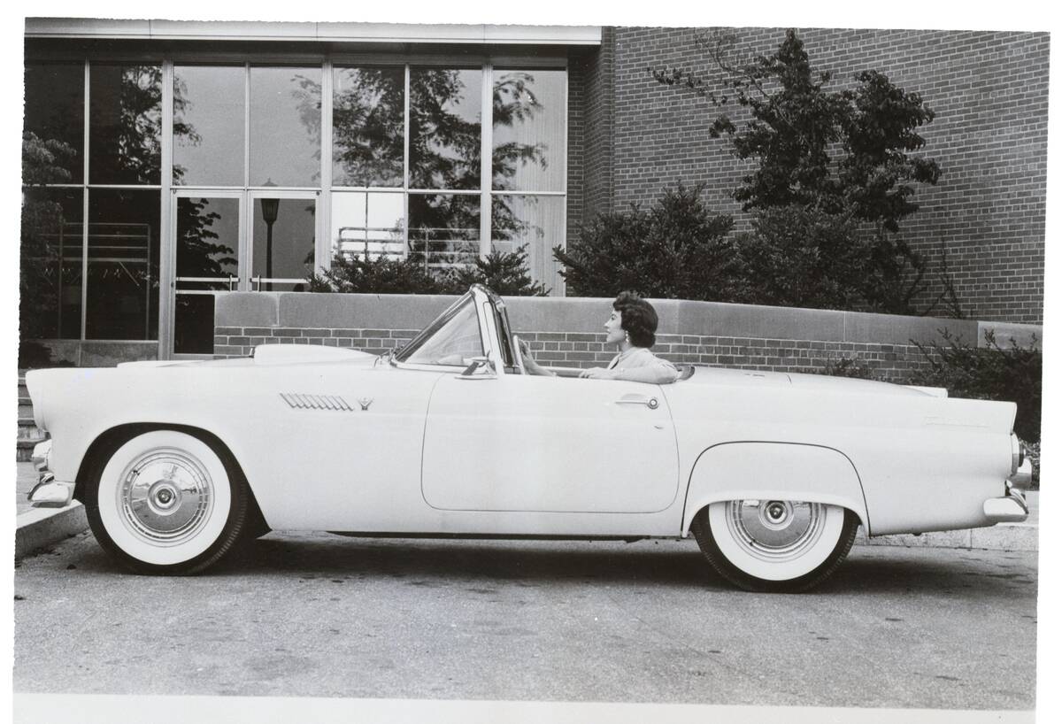Woman sitting in a Ford Thunderbird