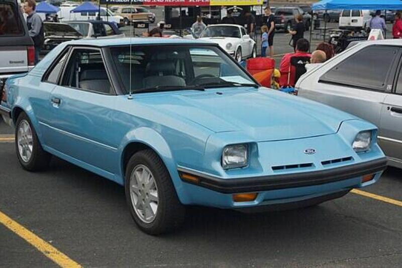 Ford EXP parked in a parking lot, next to other vehicles
