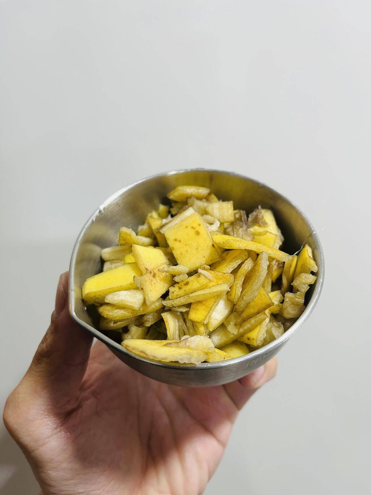 A small bowl of cut up banana peels.