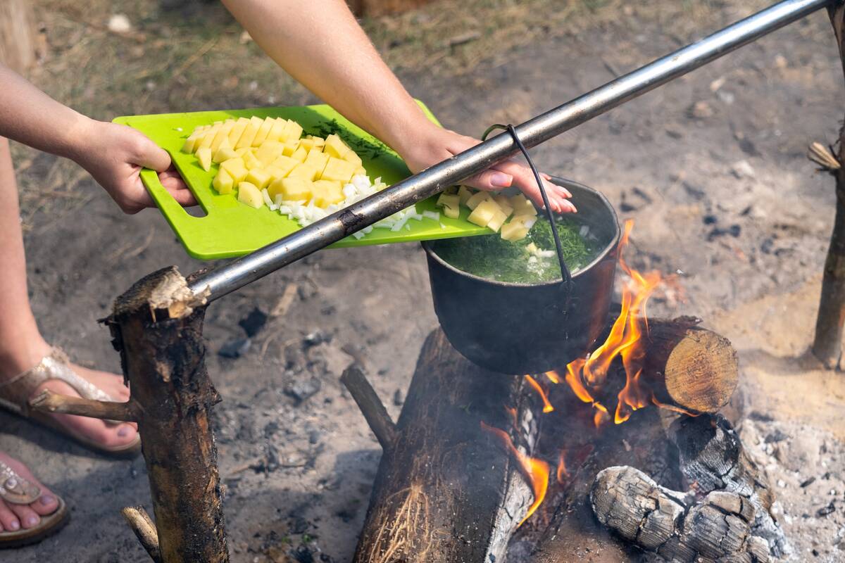 ready mushroom soup cooked over a fire is poured into a plate.