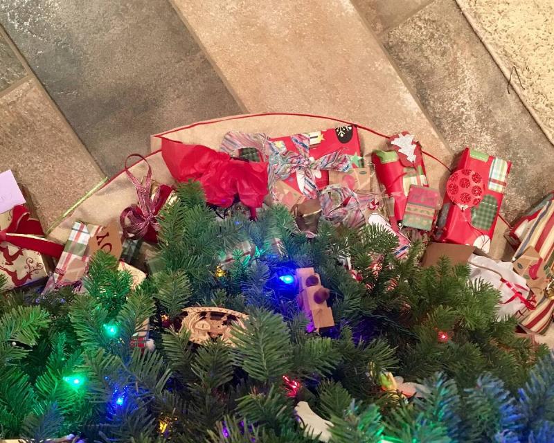 A view from the top of a Christmas tree, looking down at the presents and skirt at the base.