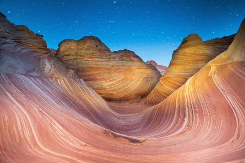 A shooting star passes over the Wave sandstone rock formation, located in Coyote Buttes North, Paria Canyon, Vermillion Cliffs Wilderness