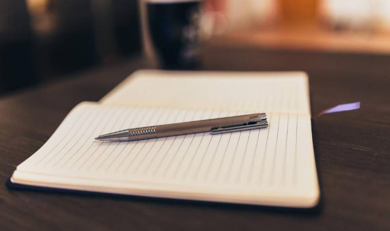 A pen on an open, empty notepad.