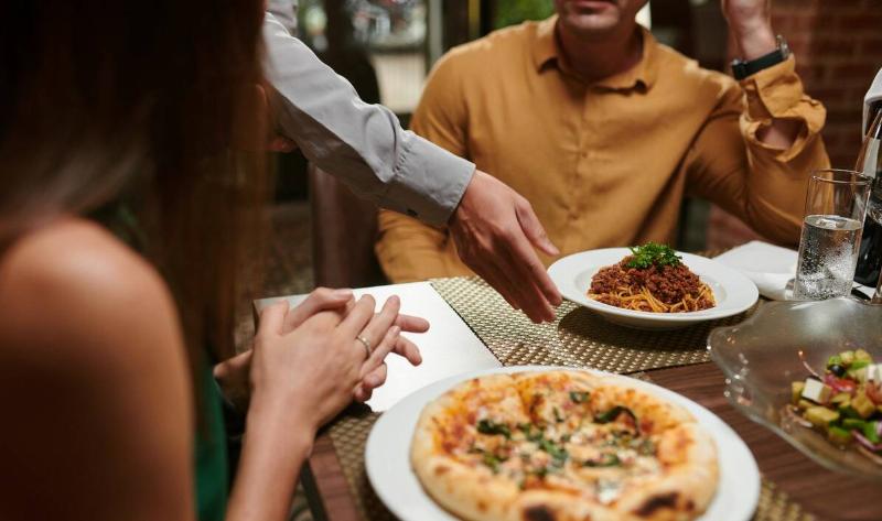 Two people at a restaurant.