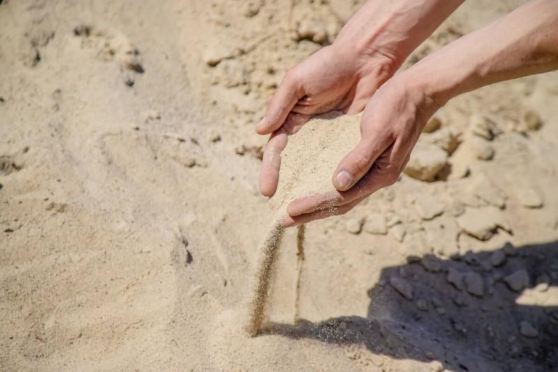Man holding sand in his hands
