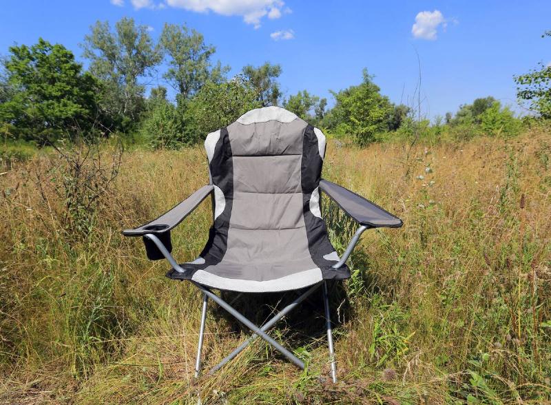 A folding camp chair in a meadow.