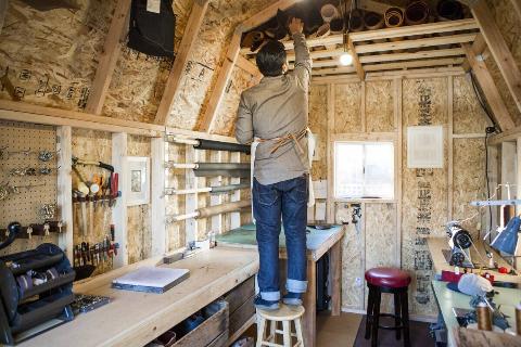 Craftsman working diligently in a cozy woodshop.