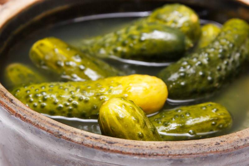 Fresh prepared homemade pickled cucumbers with spices in clay pot