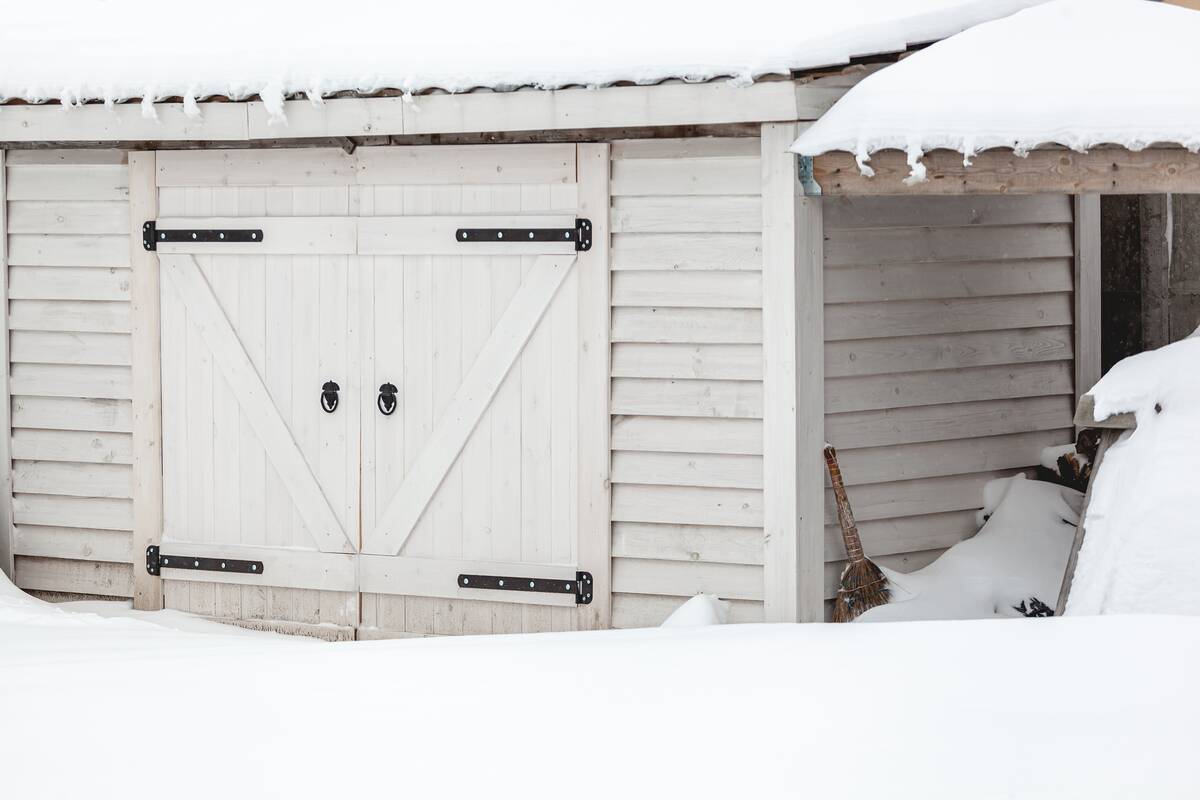 A Snow covered wooden shed after heavy snowfall