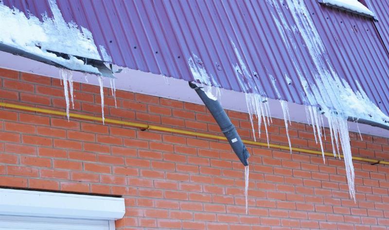 A gutter that's broken under the ice and snow.