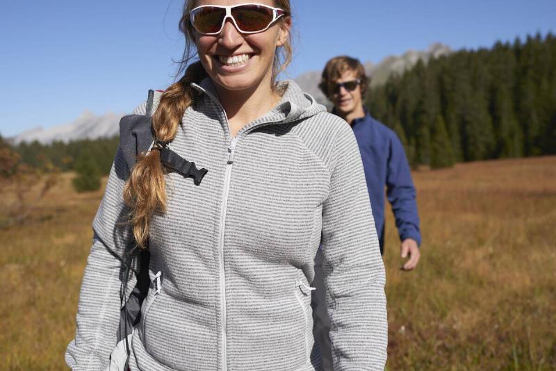 Hikers on grassy field, Manigod, Rhone-Alpes, France