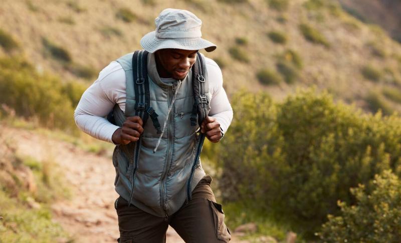 Black man, hiking and nature with travel and fitness outdoor, journey and health with wellness.