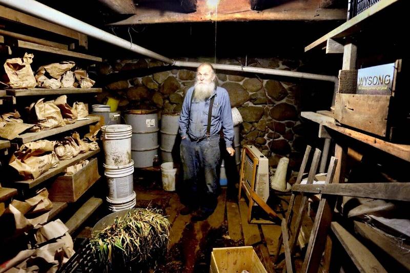 Will Bonsall in his root cellar where he keeps hundreds of different types of potatoes in brown bags