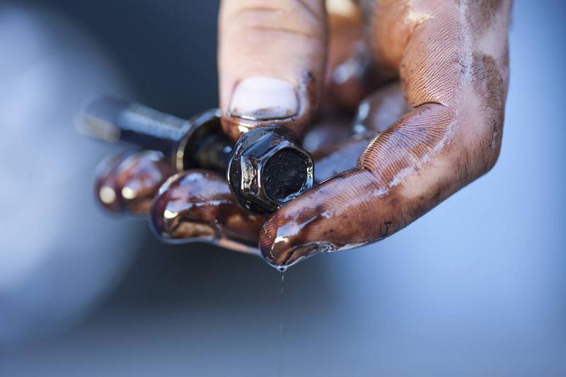 Mechanic's hands holding screw