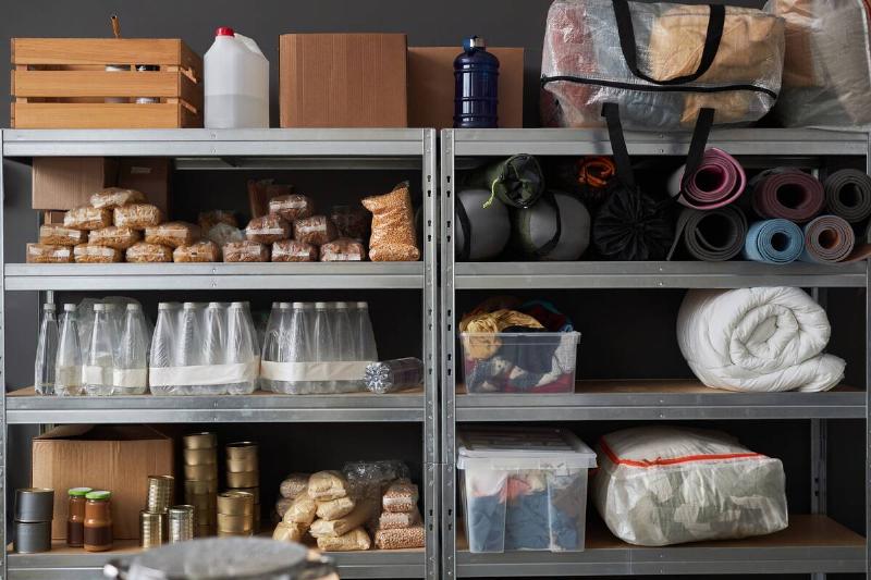 Graphic background image of stacked shelves with food and supplies in warehouse pf refugee help center, copy space