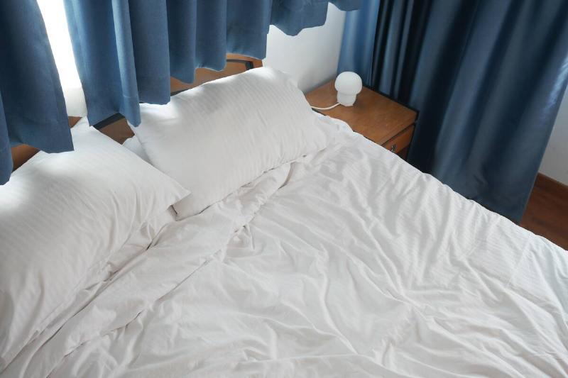 messy bed in early morning , messy bed after waking up .