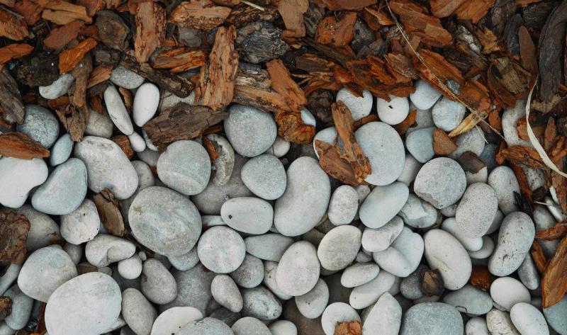 A closeup of rock mulch bordering some woodchips.