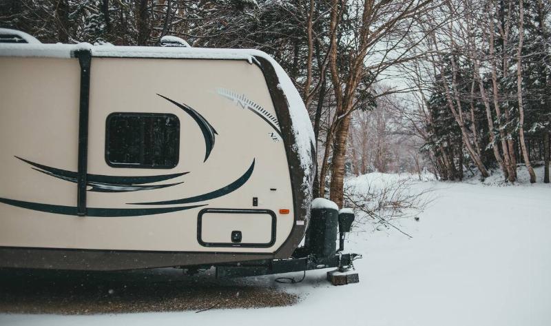An RV parked in the snow.