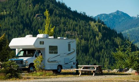 An RV parked in the mountains.