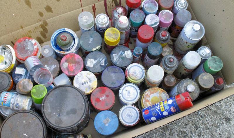 A box of various paint cans.