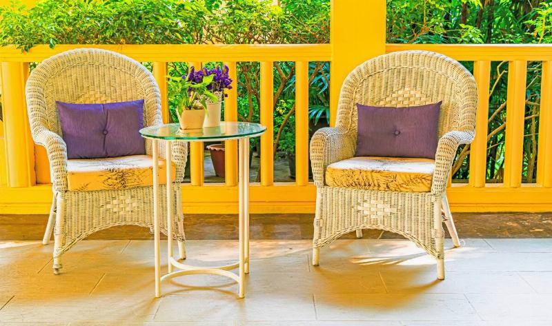 Two patio chairs with cushions.