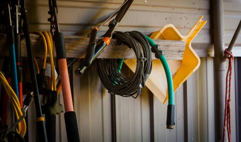 A shed shelf with various implements on it.