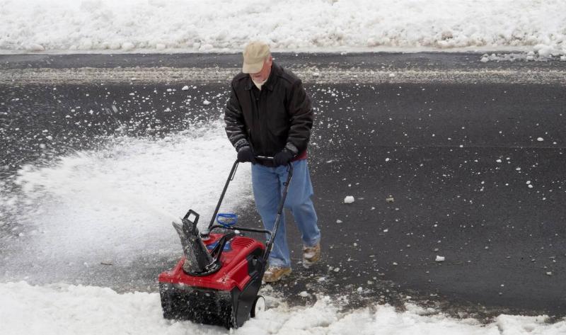 A man pushing a snowblower through tall snow.4