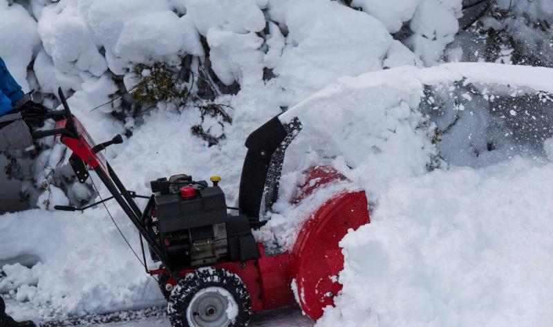 A snowblower blowing snow.