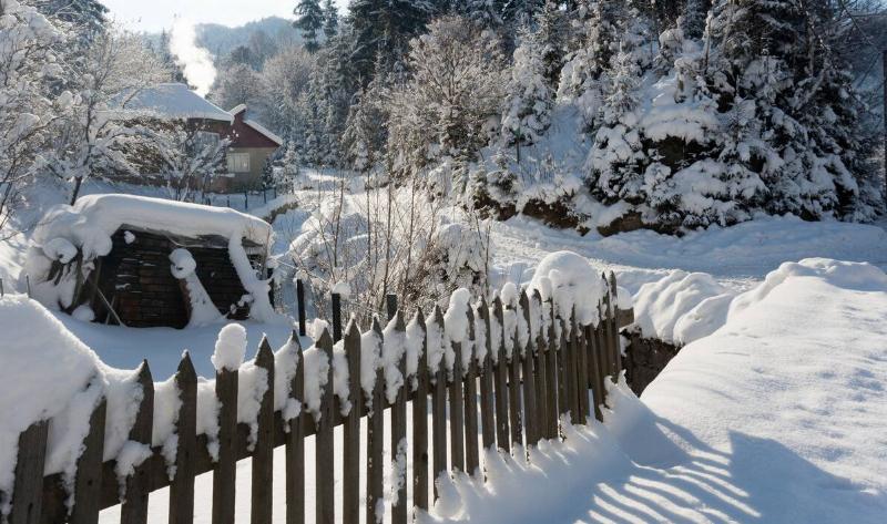 A wooden fence with snow on it.4