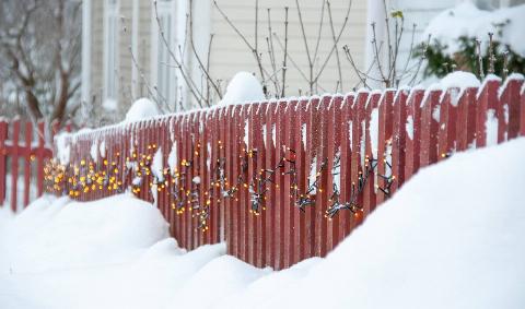 A wooden fence with snow on it.6