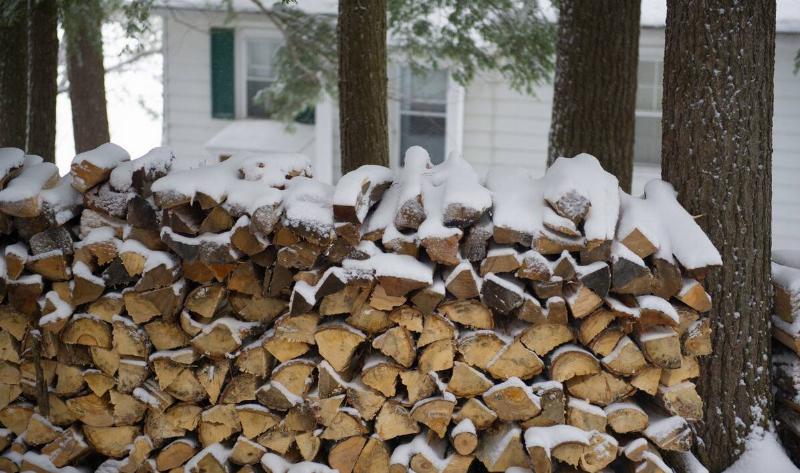 Chopped firewood covered in snow.