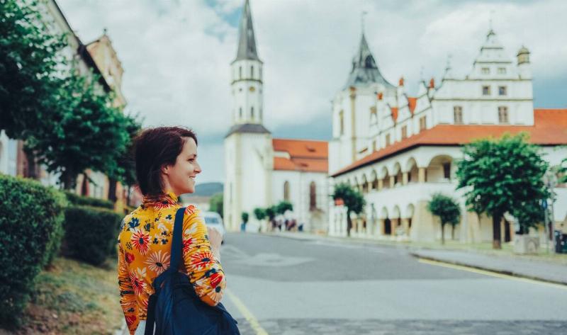 A woman walking down a European street.