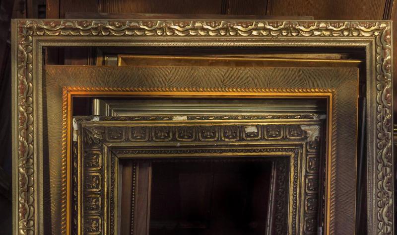 A stack of empty, ornate picture frames.