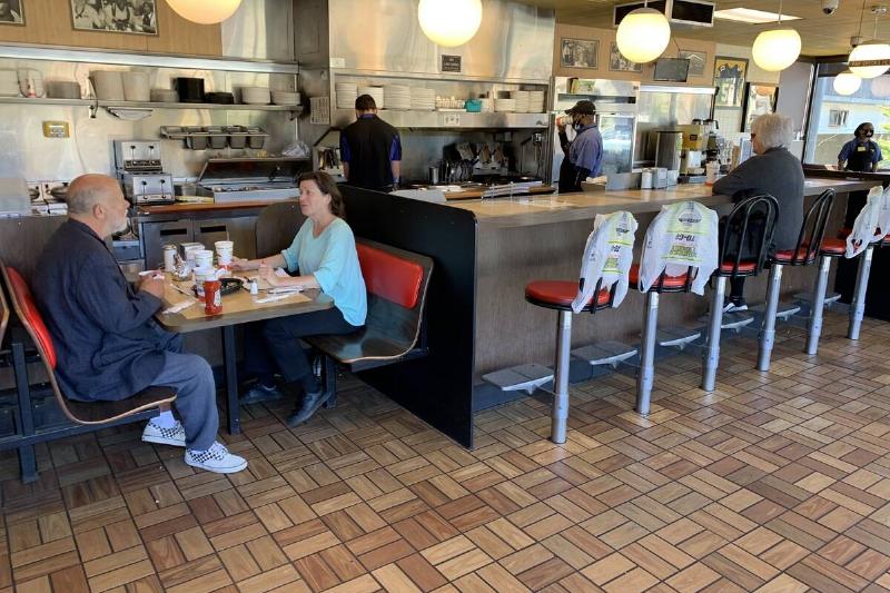 Patrons sitting at tables in a Waffle House