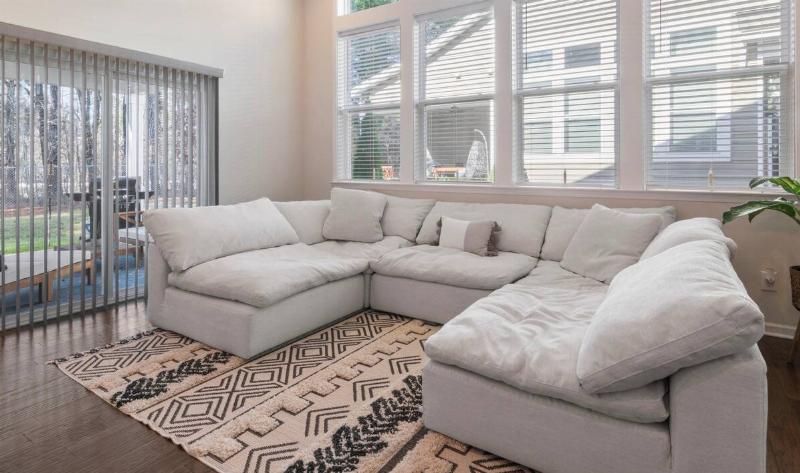 A living room with a rug on the floor.