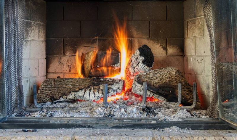 A lit fireplace with plenty of visible ash.