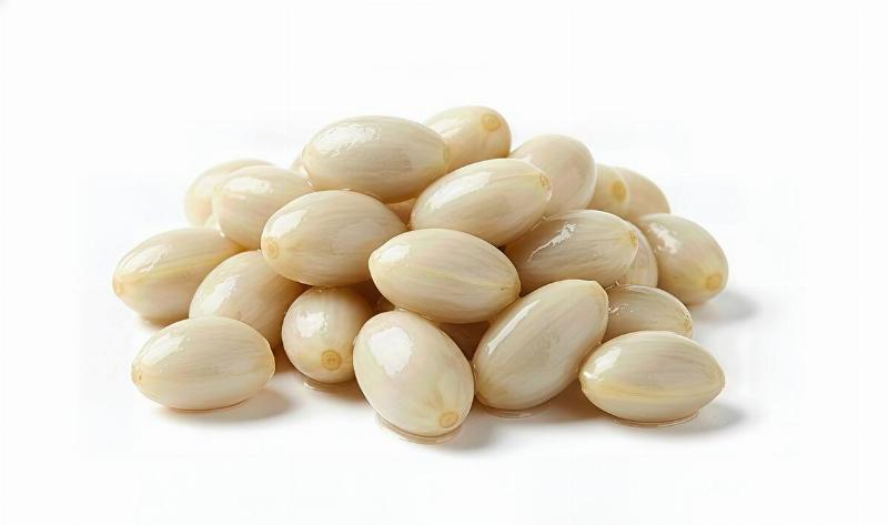 A pile of lemon seeds against a white background.
