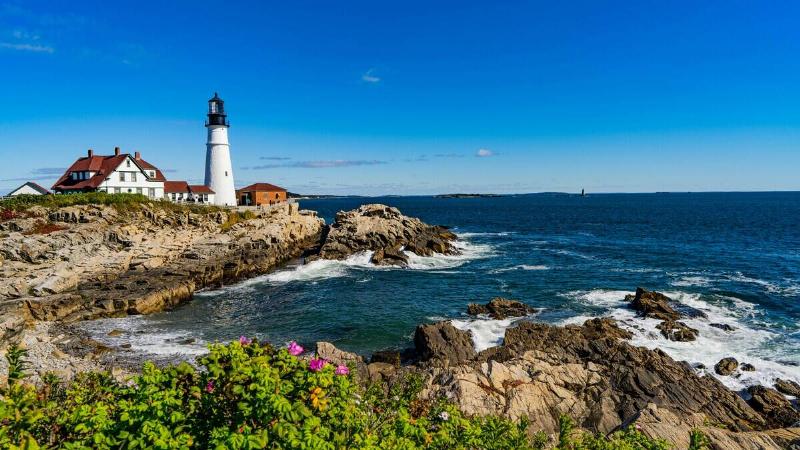 A lighthouse on the rocky coast of Portland, Maine.