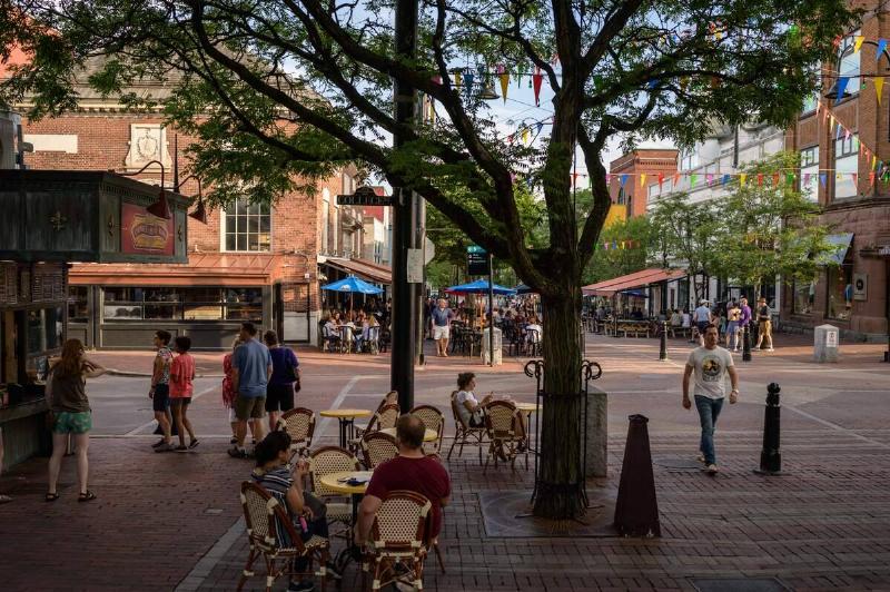People walk along Church street in Burlington, Vermont on June 28, 2021.