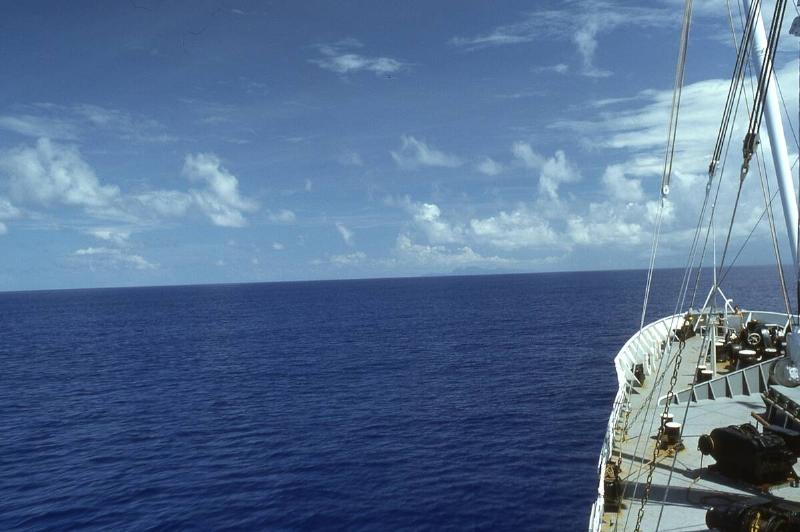 Prow of a commercial boat in the ocean at midday, with winches and rigging visible, low cloud cover and flat water, the Fiji Islands, Republic of Fiji, 1976.
