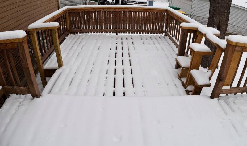 A wooden deck covered in snow.
