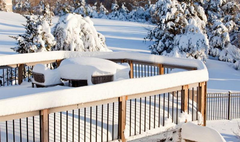 A wooden deck covered in snow.