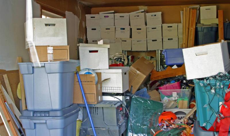A garage filled with stacks of cardboard boxes.