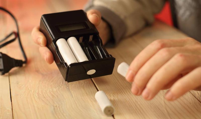 A person putting batteries into a pack.