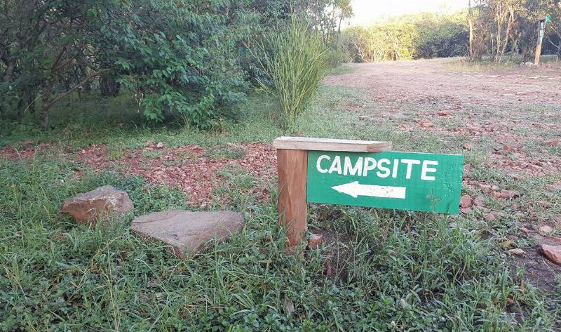 A small sign pointing toward a campsite.
