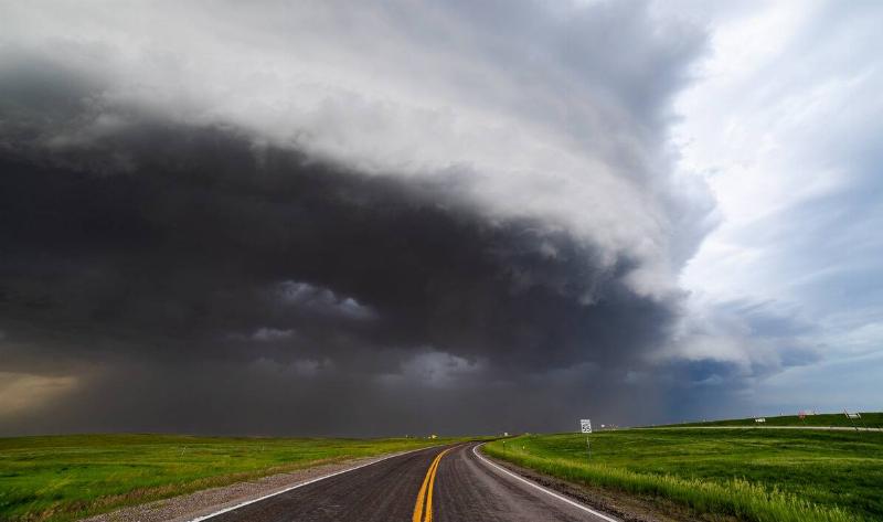 A derecho rolling across a road.