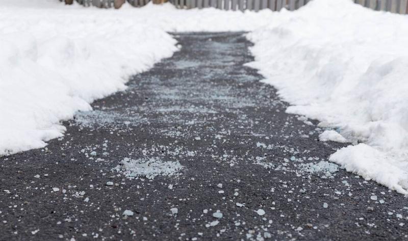 A sidewalk covered in road salt.