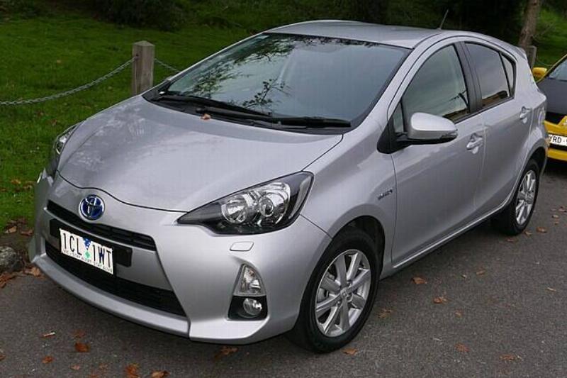 Silver 2014 Toyota Prius C parked along the side of a road