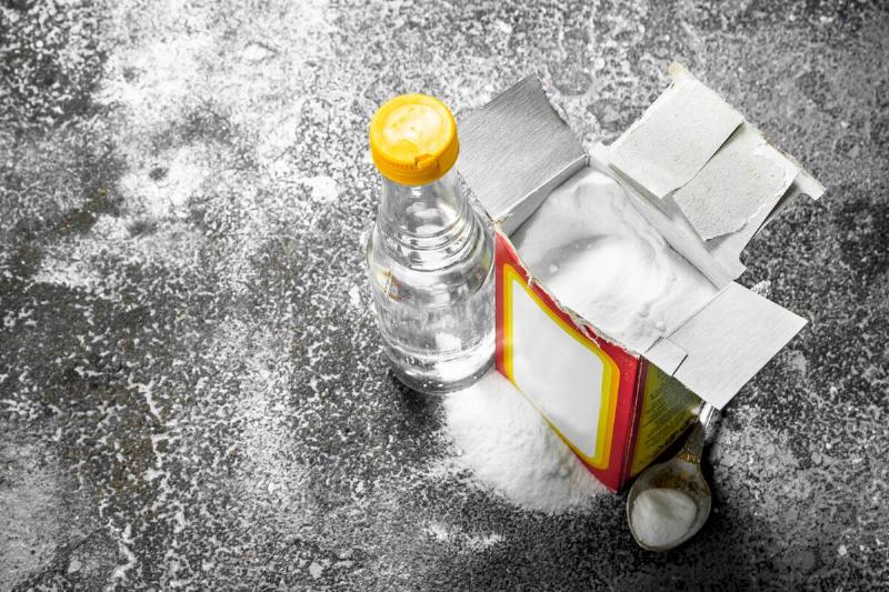 A box of baking soda and a bottle of vinegar. 