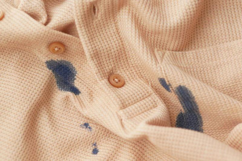 Beige shirt with blue ink stain.